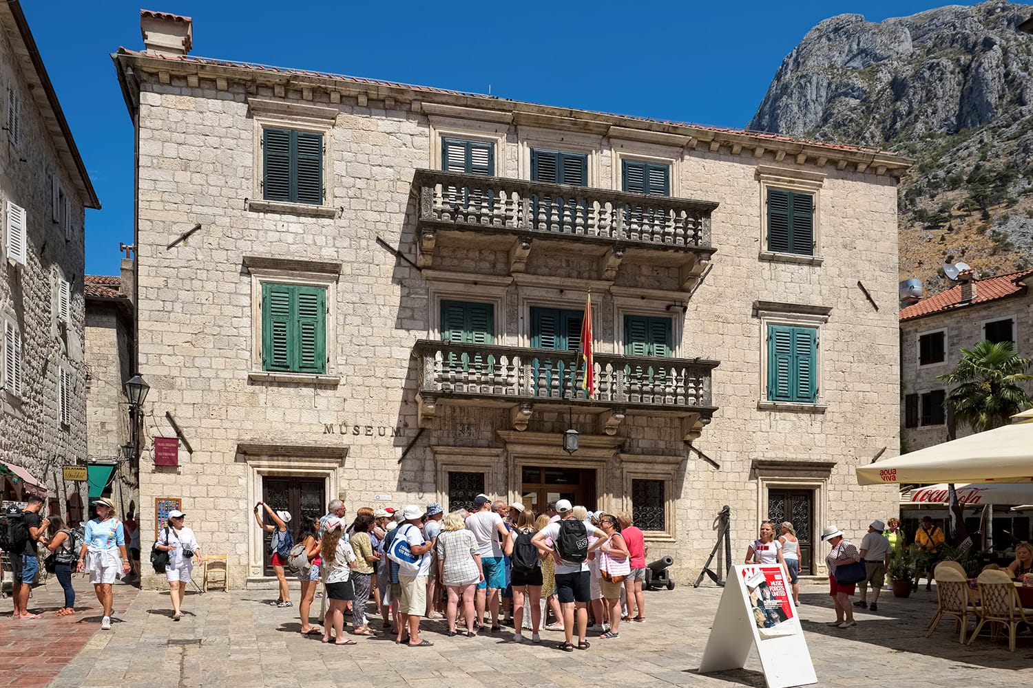 Tourists near the Maritime Museum located in the Grgurina Palace, Kotor, Montenegro