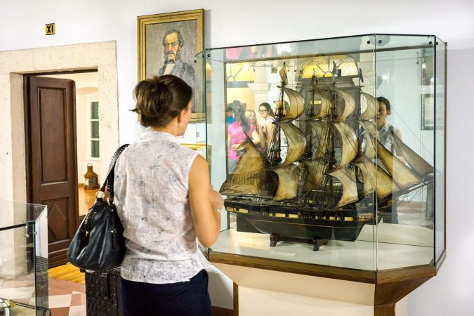 Maritime Museum of Montenegro. Visitor looking at the vessel model in the museum hall.