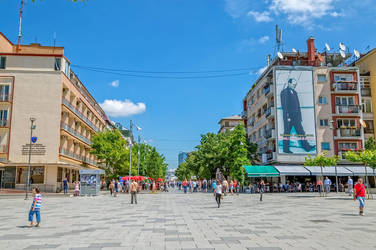 People walking on Mother Teresa street in the city center.