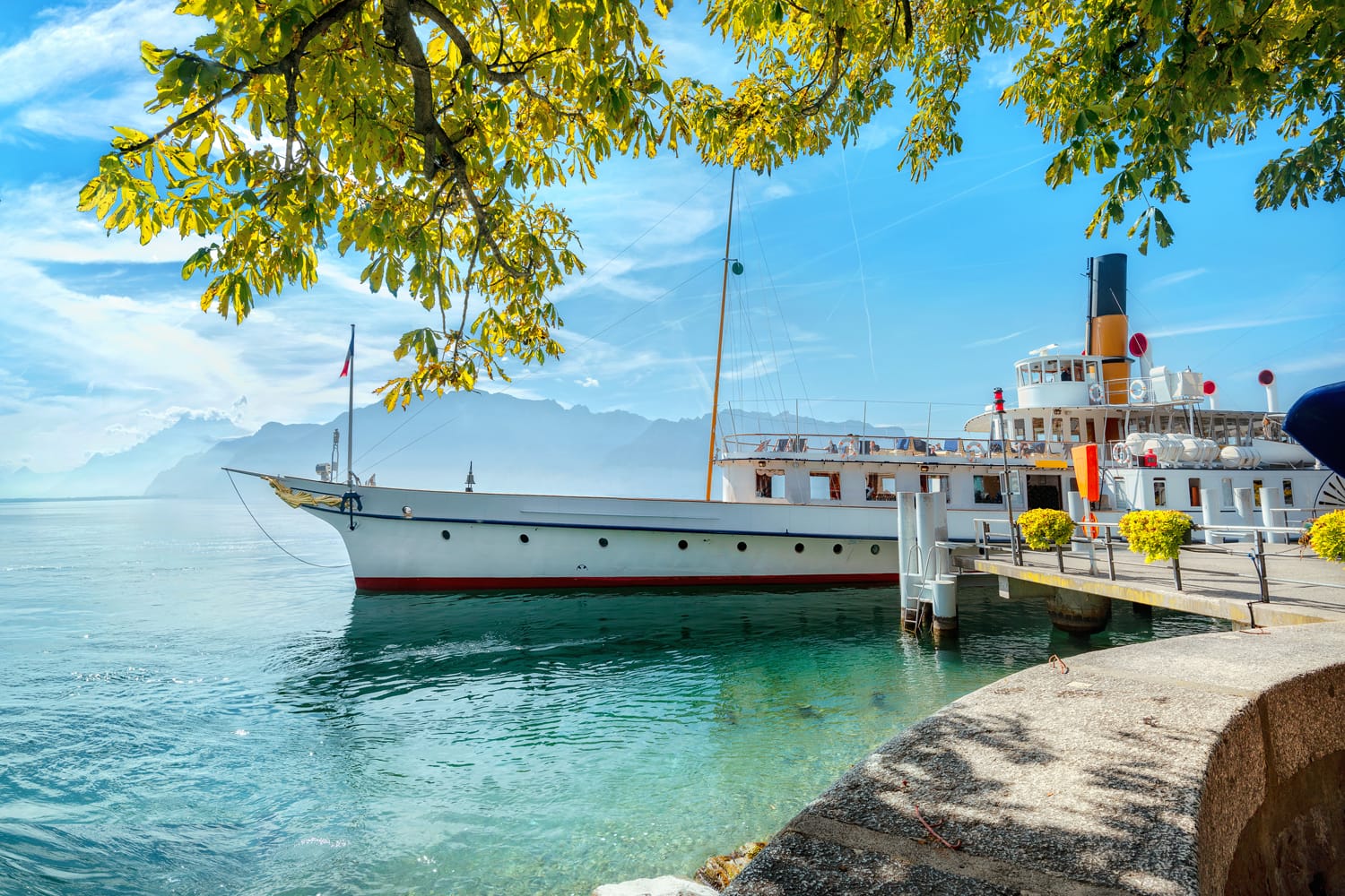 Panoramic view of Geneva Lake with touristic old ferry in Vevey town. Vaud canton, Switzerland