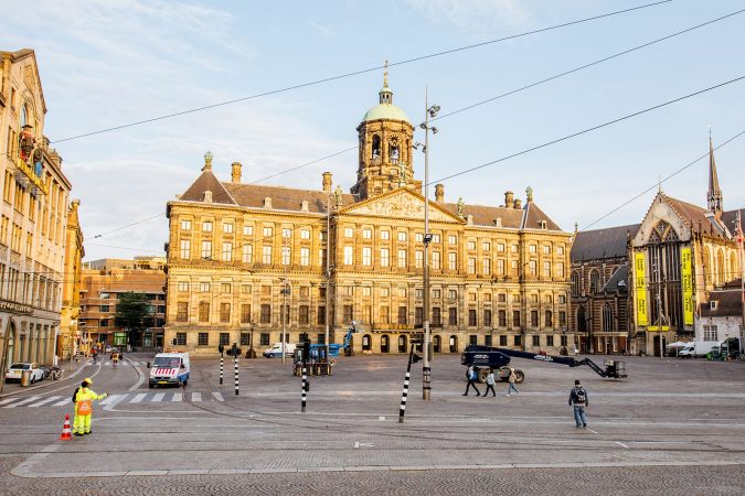 Morning view on the central Dam square with Royal palace and Nieuwe church in Amsterdam, Netherlands