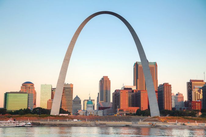 Downtown St Louis, MO with the Old Courthouse and the Gateway Arch at sunrise
