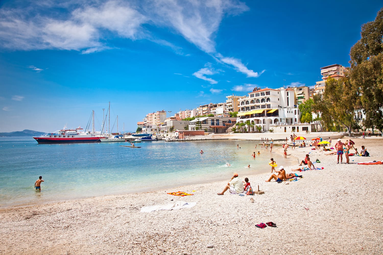 Unidentified tourists on pablic beach in Saranda, Albania. Saranda is one of the most important and most popular resorts on the Albanian coast.