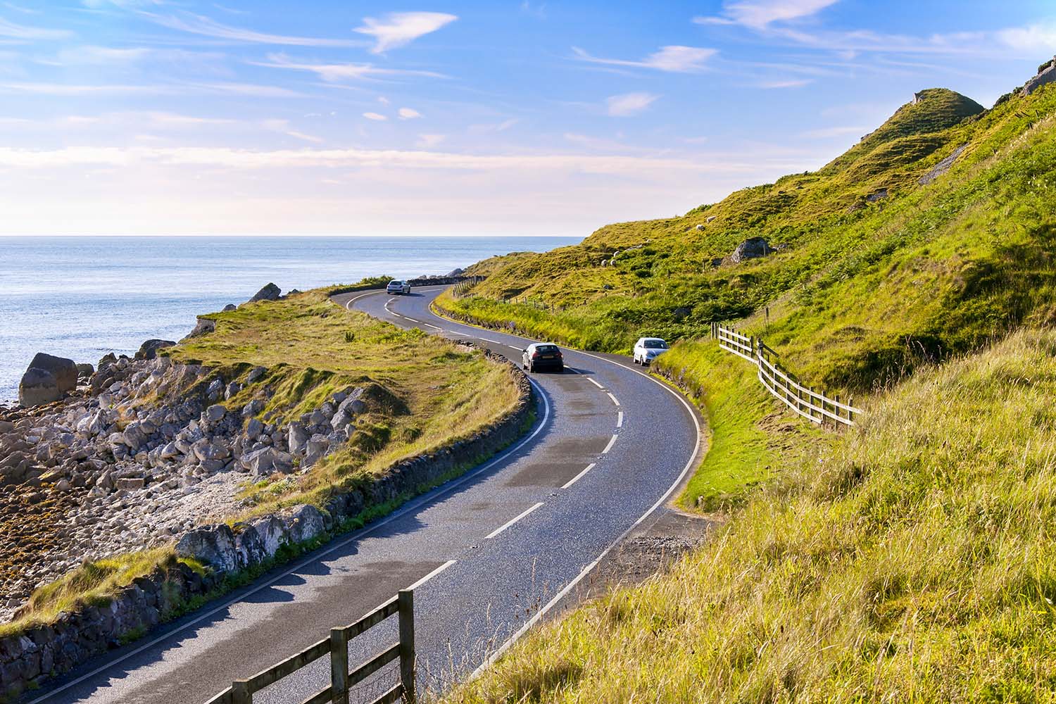 The eastern coast of Northern Ireland and Antrim Coastal road with cars