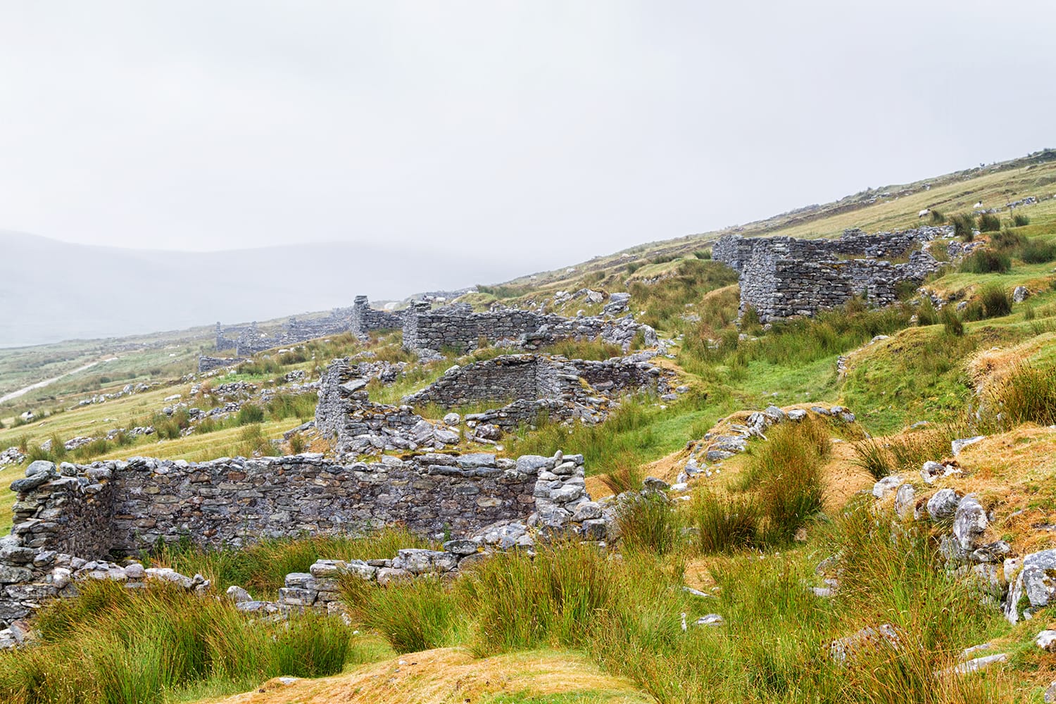 Abandoned dry stone cottages in the deserted village of Slievemore in Achill Island, Ireland