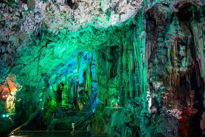 Tourists explore Old St. Michael's Cave, that has been illuminated with colorful LED lighting, located at the Upper Rock Nature Reserve at Gibraltar.