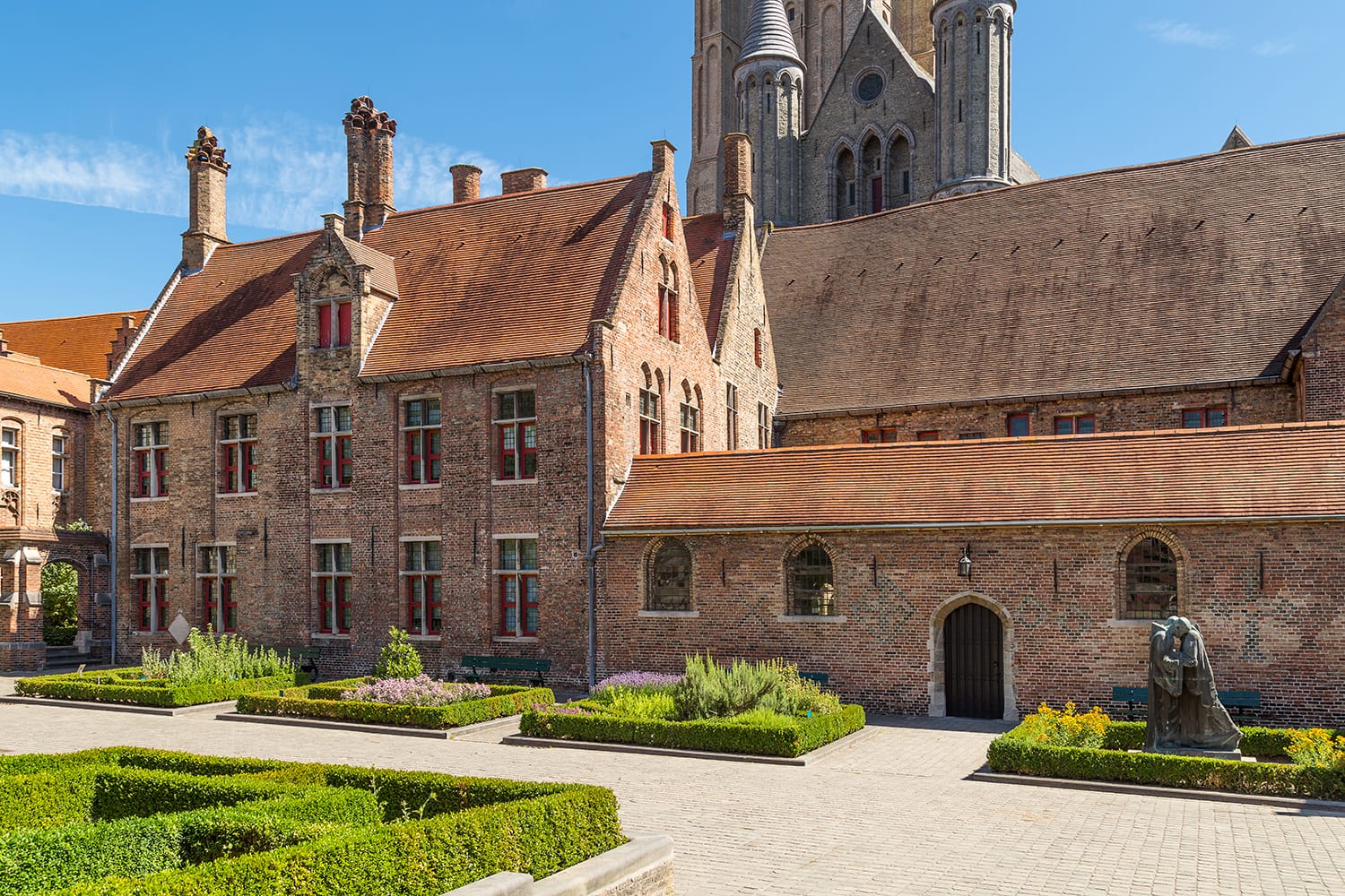 Typical medieval Flemish architecture of Bruges, Belgium. Red brick houses and towers of a former hospital of Saint John.