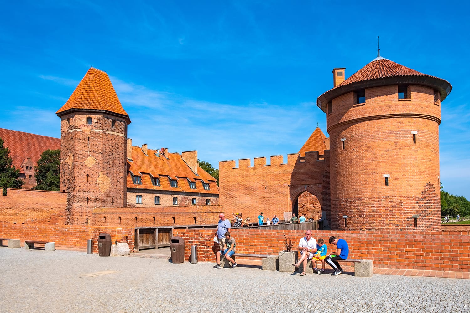 Panoramic view of the medieval Teutonic Order Castle in Malbork, Poland - external defense walls with lower castle gate tower and drawbridge over the moat