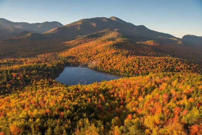 Morning light illuminates the fall color in the Adirondack mountains, NY, USA
