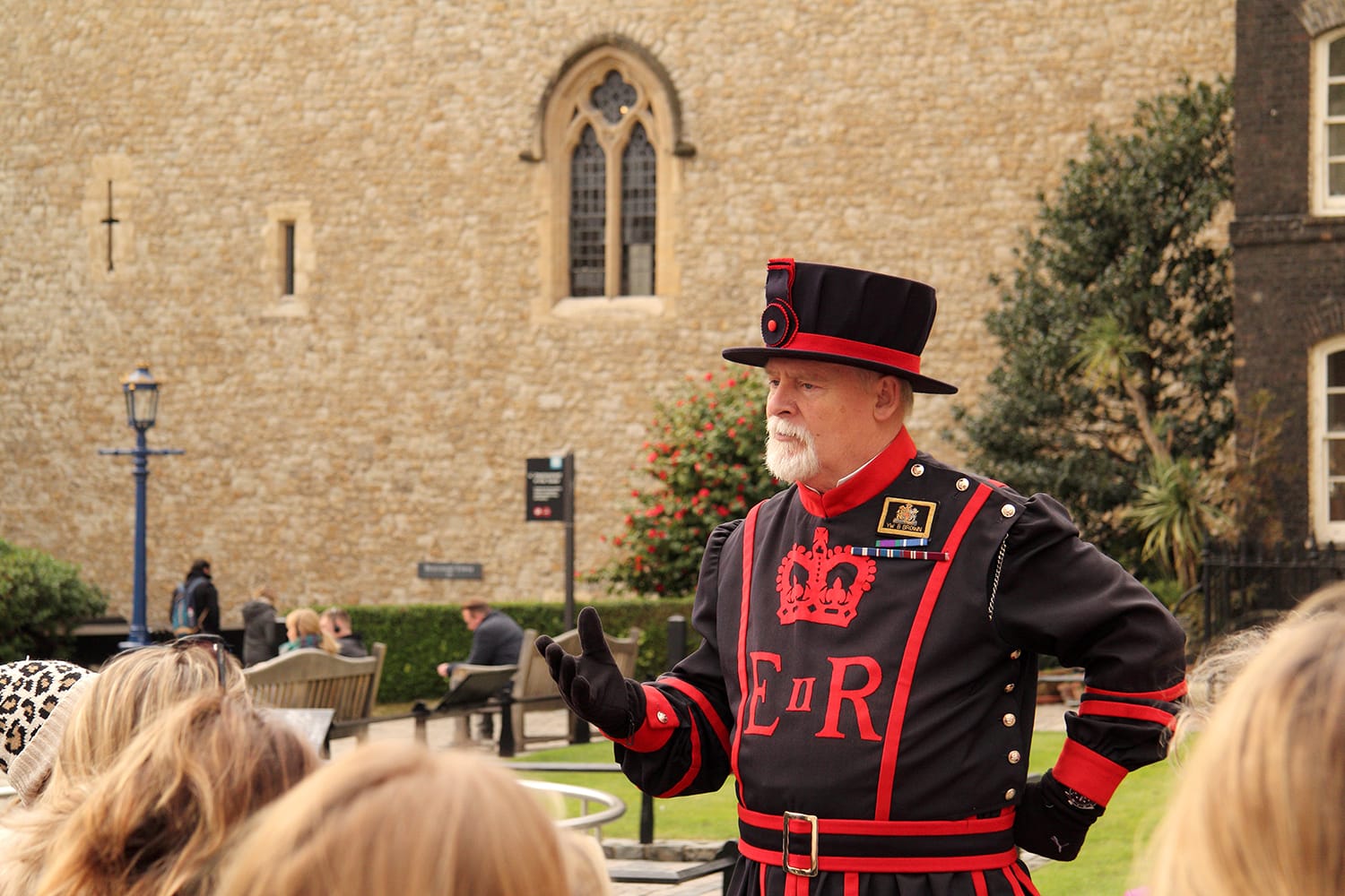 A Yeoman Warder leads visitors on a tour through the Tower of London