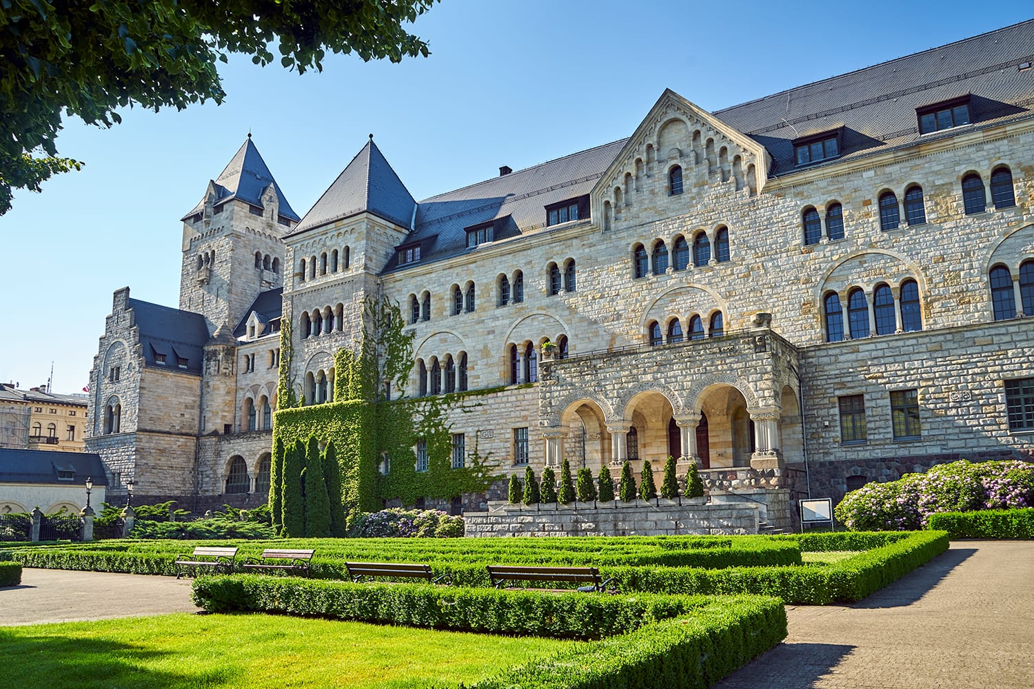 A historic stone imperial castle with a garden in Poznan, Poland