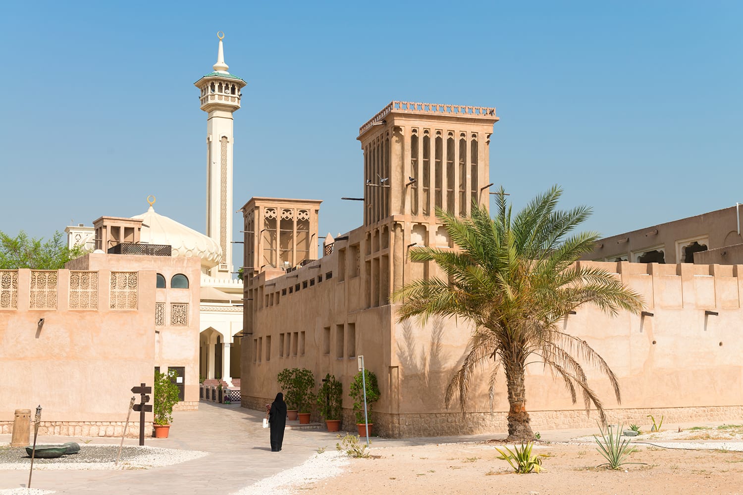 A woman in traditional muslim black dress in old Arabic City district