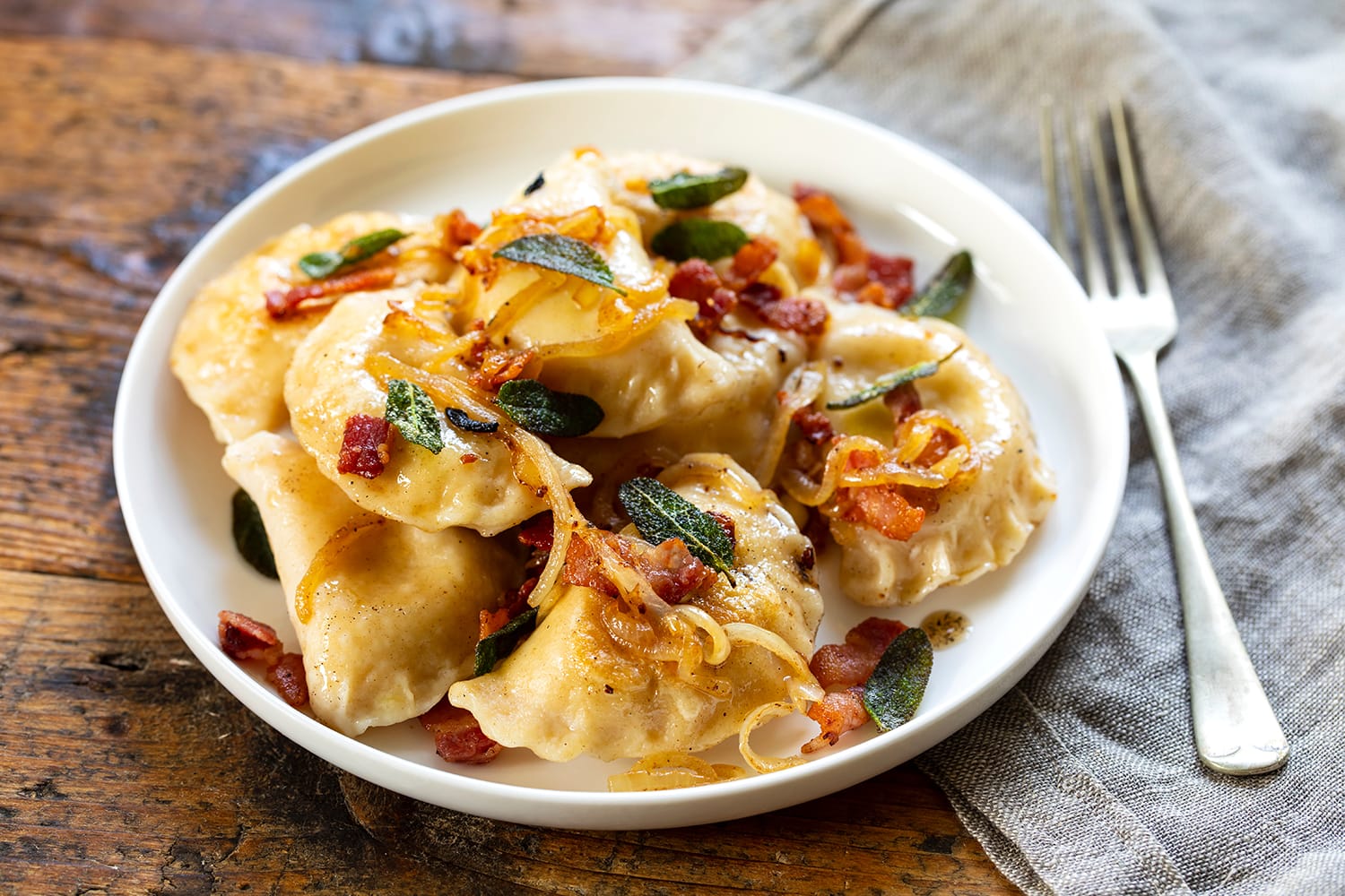 Traditional polish pierogi with crispy bacon and onion