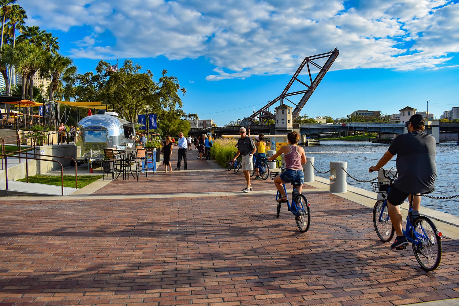 People biking and walking along the Tampa Riverwalk