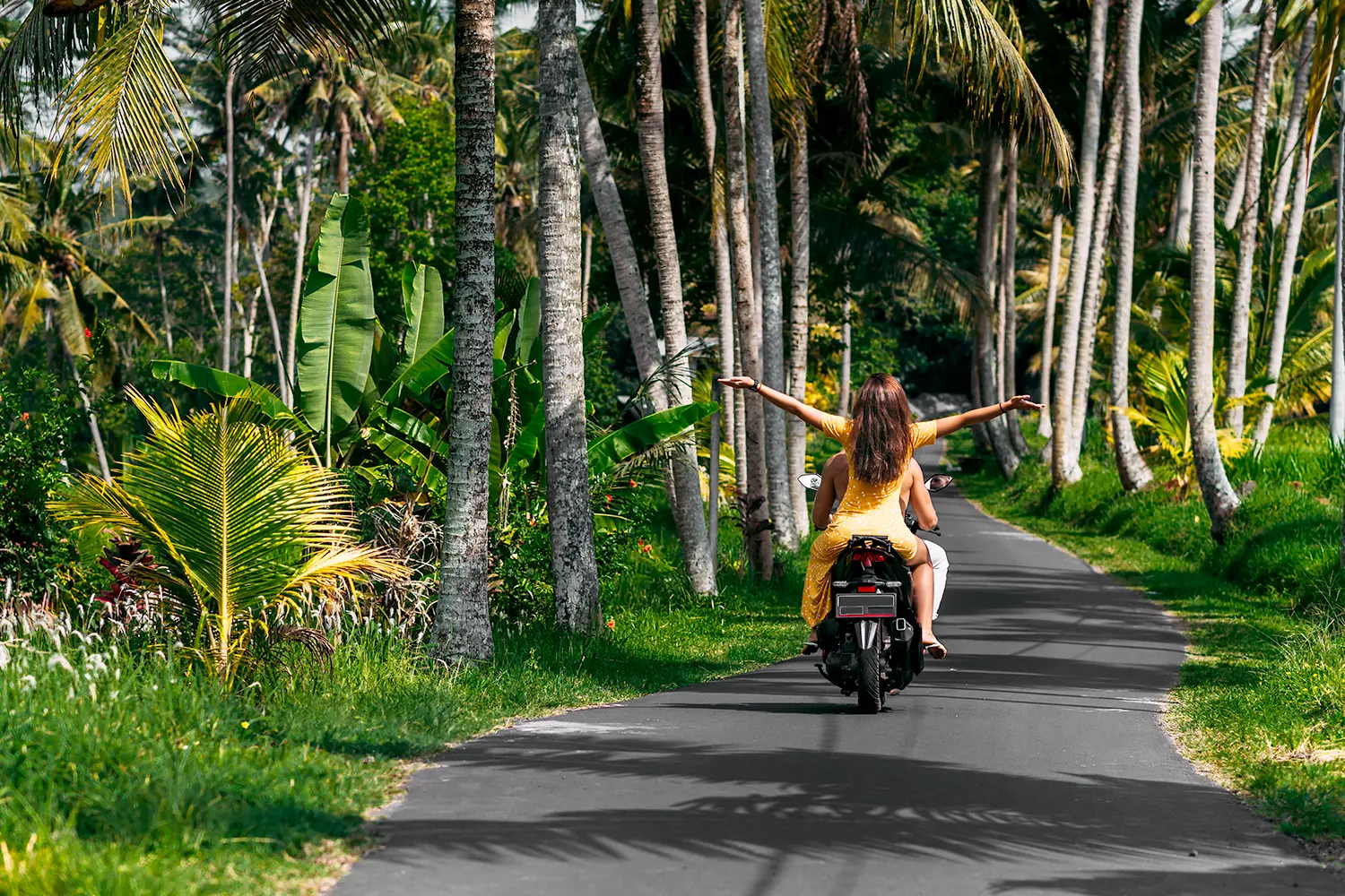 Couple driving scooter on Bali