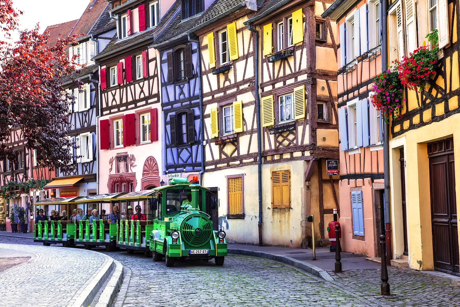 Tourist train driving through old town Colmar, France
