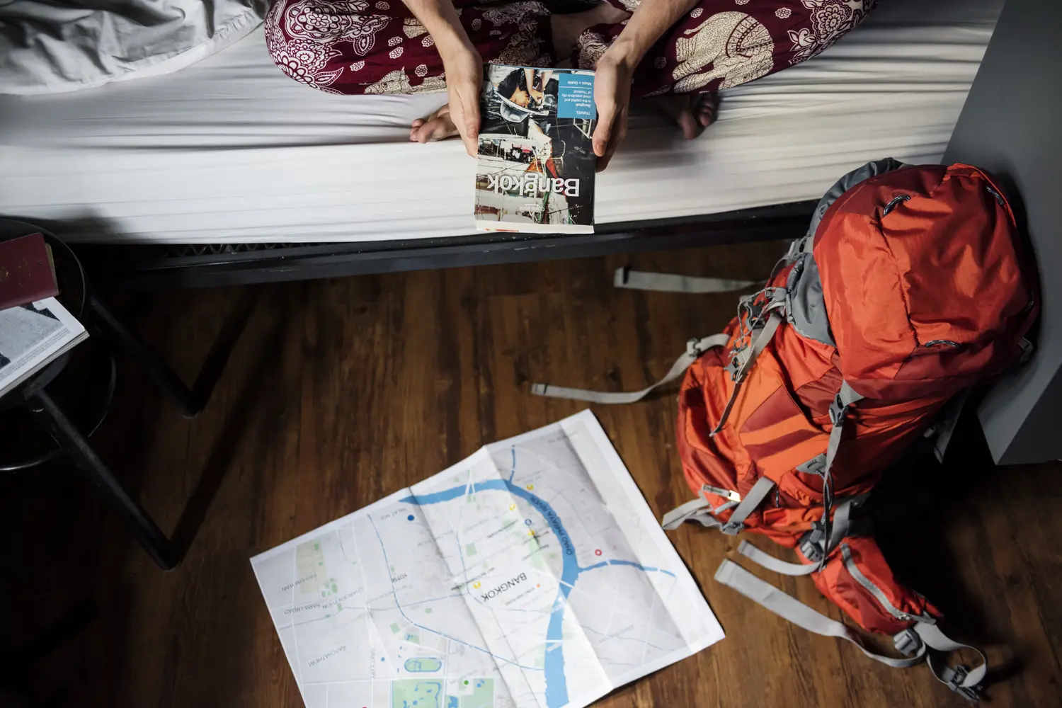 Traveler sitting on hostel bed in Bangkok, Thailand