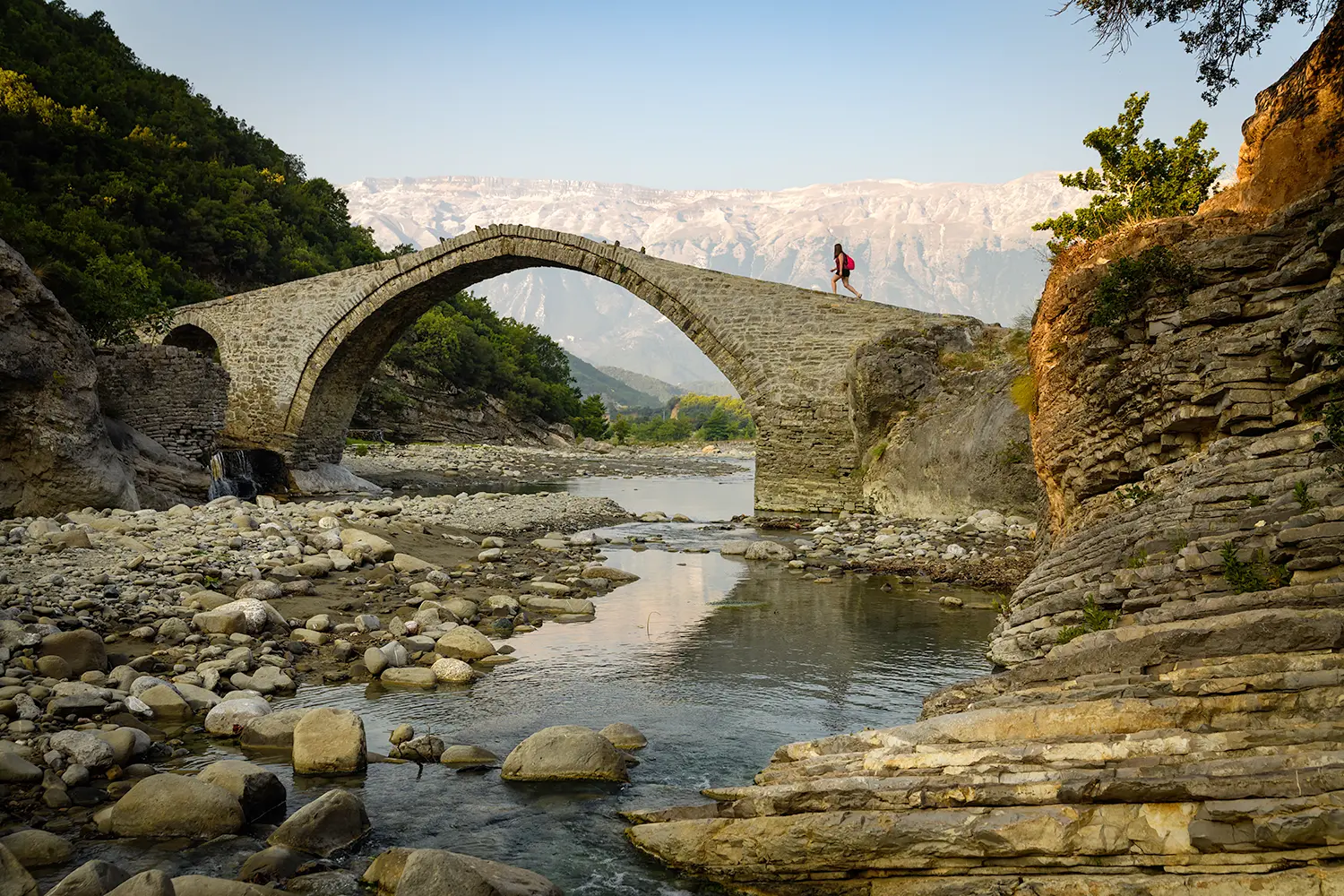 View of the old stone Ottoman Bridge (Katiu Bridge) and thermal springs of Benja near Permet. Lengarica canyon, Fir of Hotova National Park.