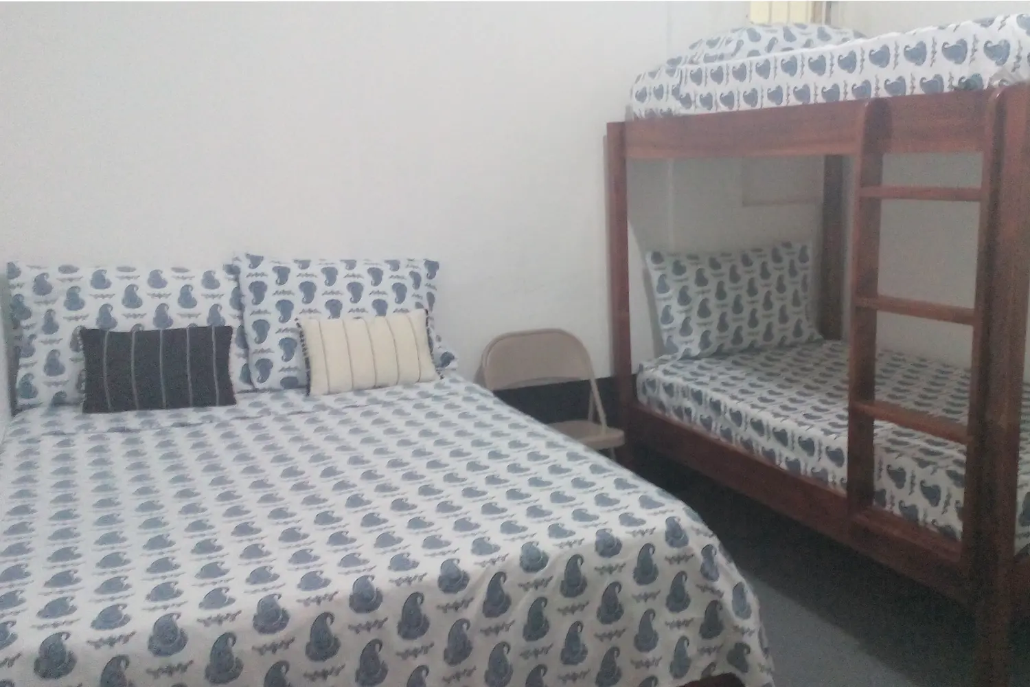 A bed and a bunk bed in a room at Drifters@One Mile