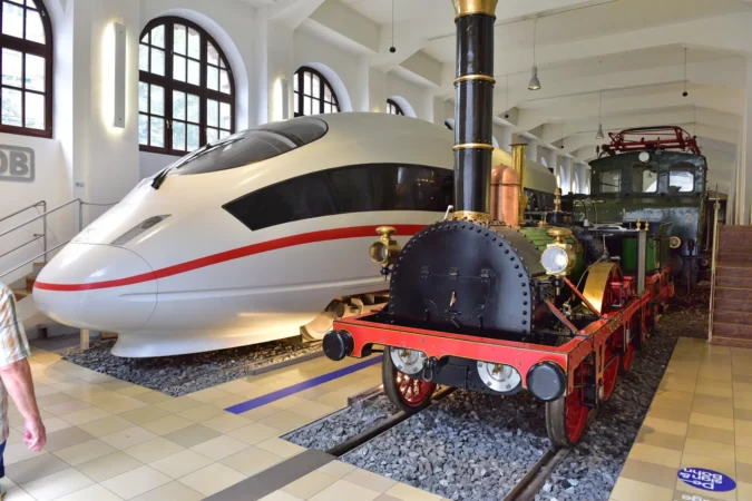 Museum of the Deutsche Bahn in Nuremberg - the modern ICE next to a replica of the first German locomotive Adler