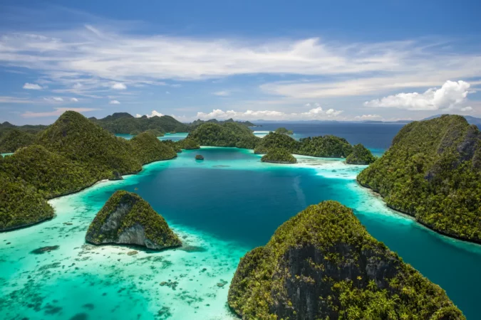 Limestone islands rise from a gorgeous lagoon in Wayag, Raja Ampat, Indonesia.