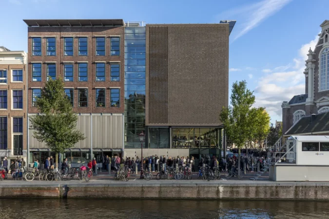 Amsterdam, Netherlands - October 10, Long waiting line in front of the ticket office to enter the Anne Frank house and war museum seen from the other side of the canal in Amsterdam