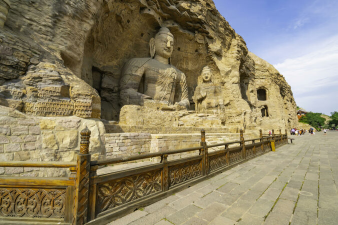 Ancient giant Buddhas statues carved on a mountain. Yungang Grottoes near Datong, Shanxi province, China.