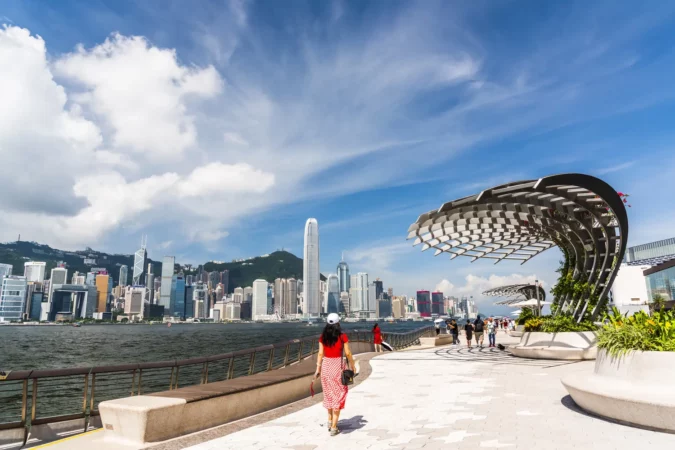 Tourists visiting the Avenue of the Stars. The Avenue of Stars is located along the Victoria Harbor in Hong Kong.