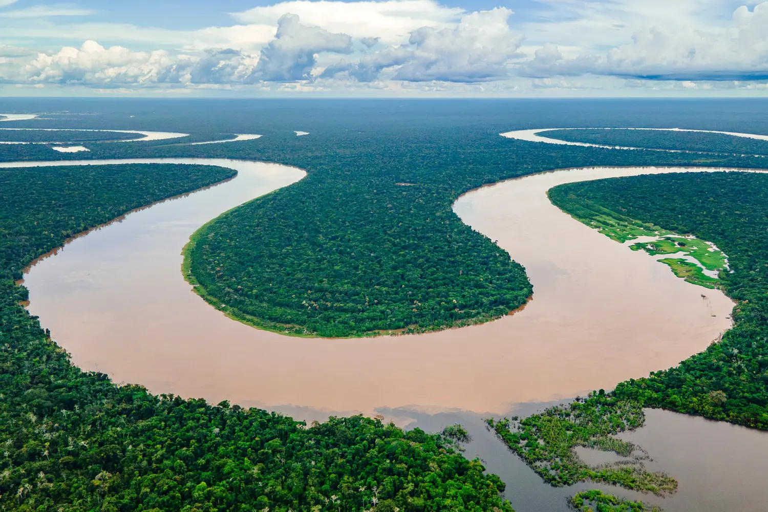 Aerial view of the Amazon River winding through dense forests in Amazonas, Colombia