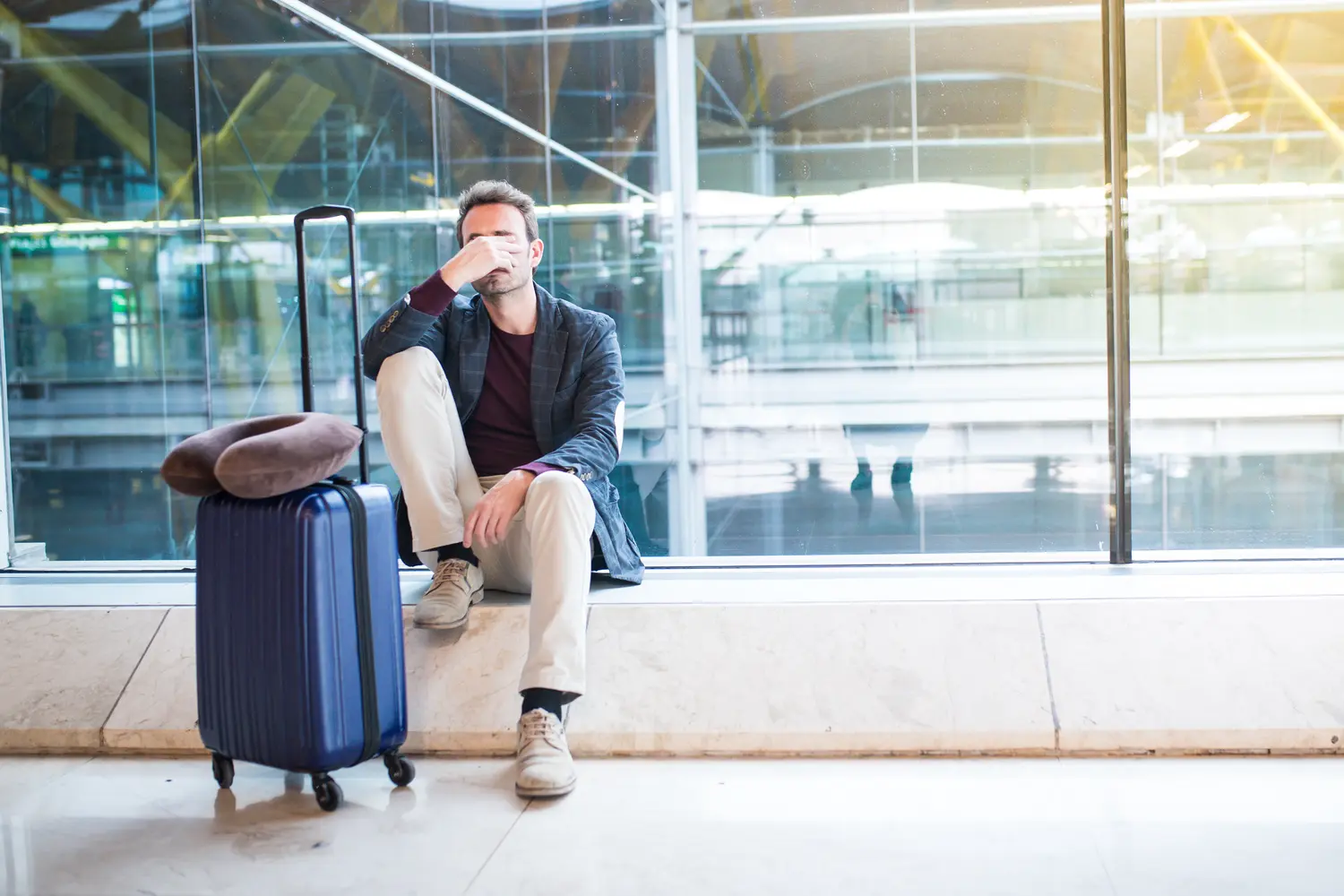 Man upset at the airport his flight is delayed