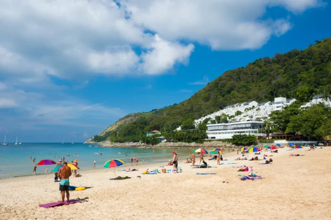 Tourists on the Nai Harn beach - one of the best beaches in Phuket, Thailand
