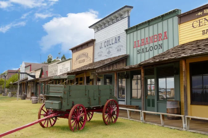 Façade of the Front Street replica with an old chuck wagon at the Boot Hill historical museum in Dodge City, Kansas.