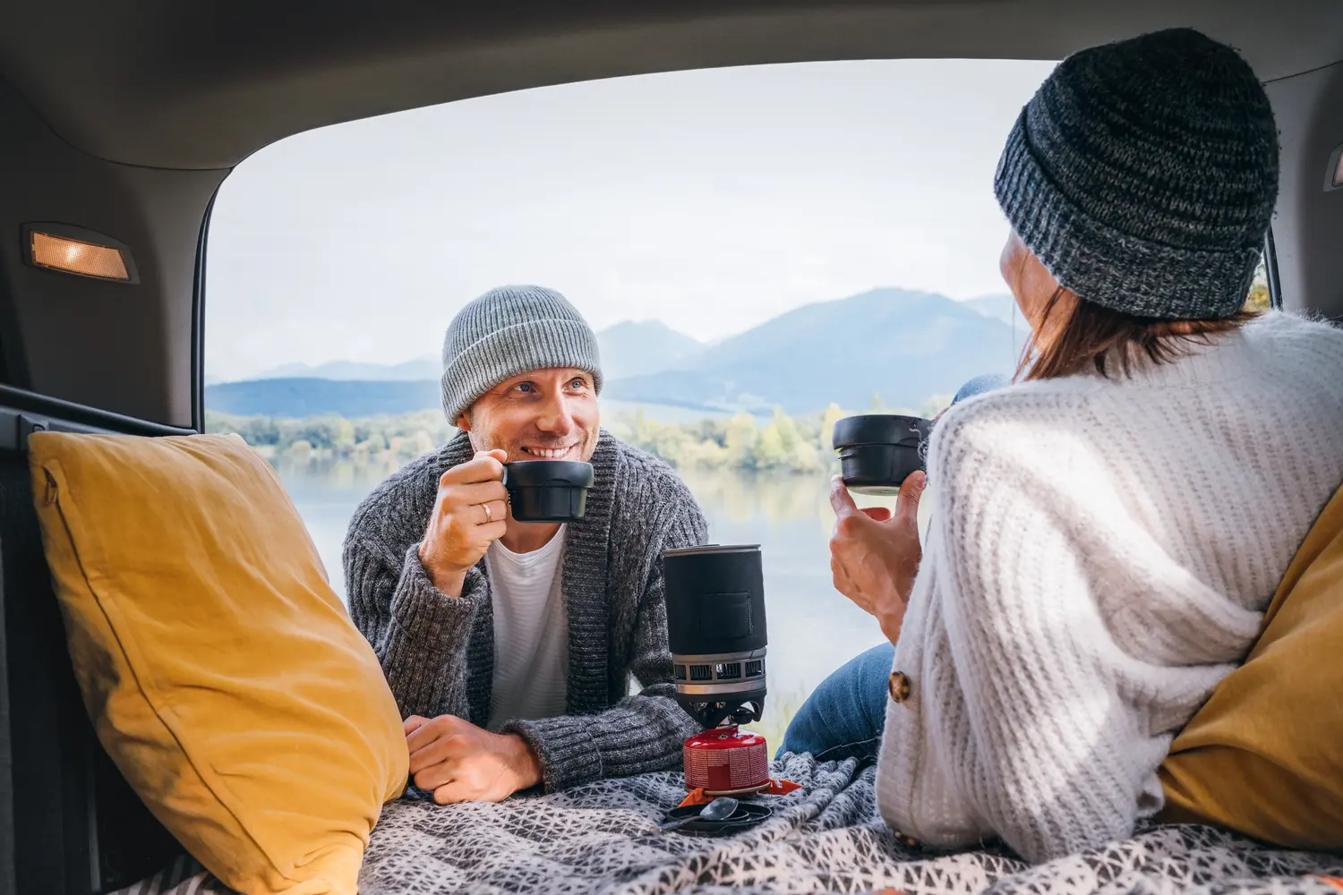 Couple drinking coffee in car