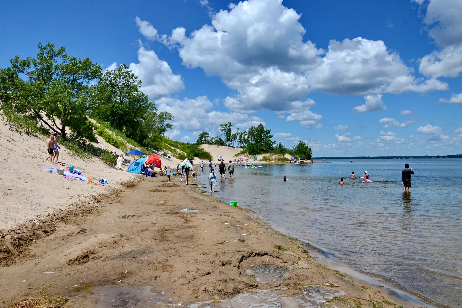 People sunbathing in Sandbanks Provincial Park in Ontario, Canada
