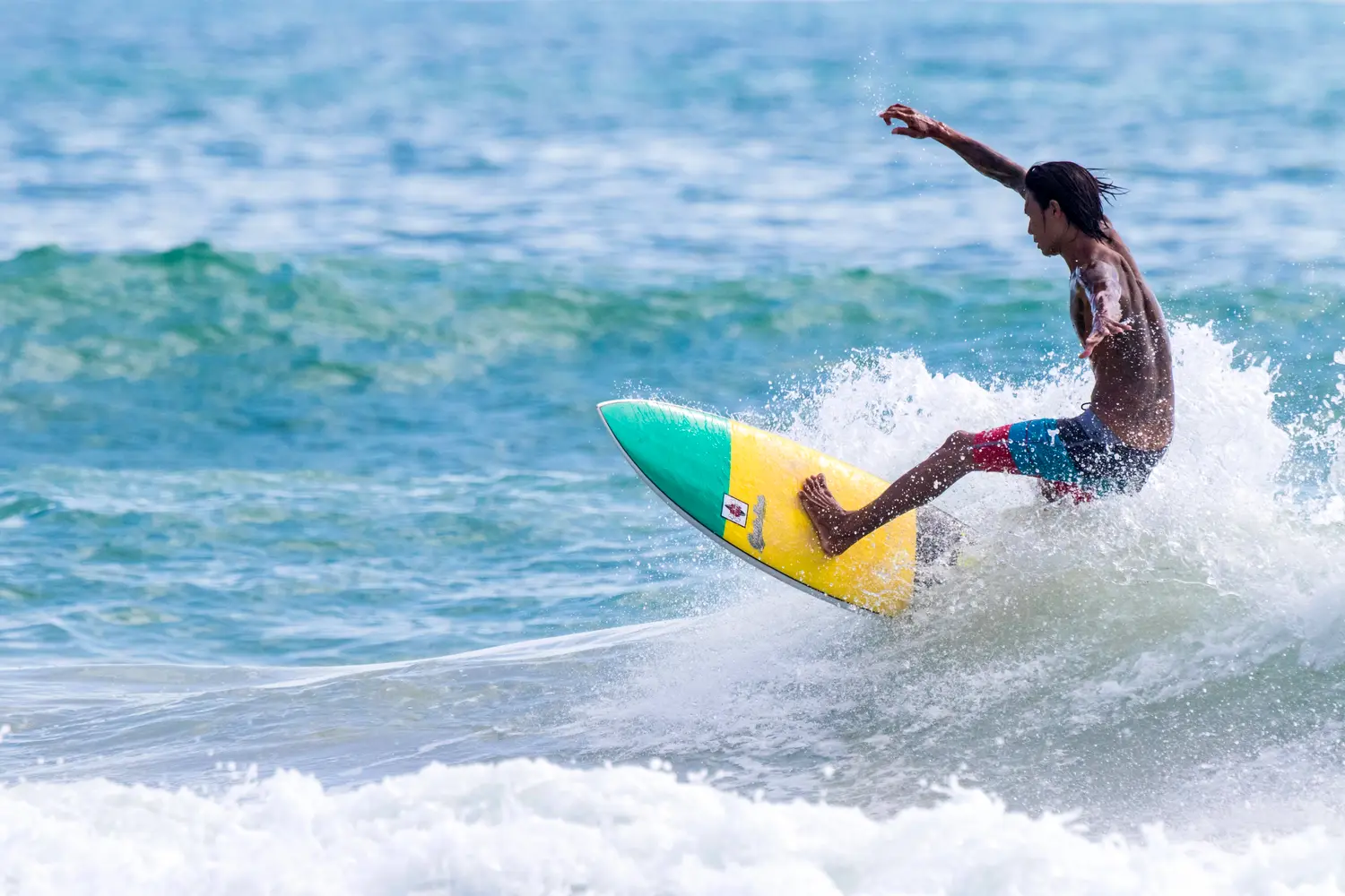 Thai man surfing in Thailand