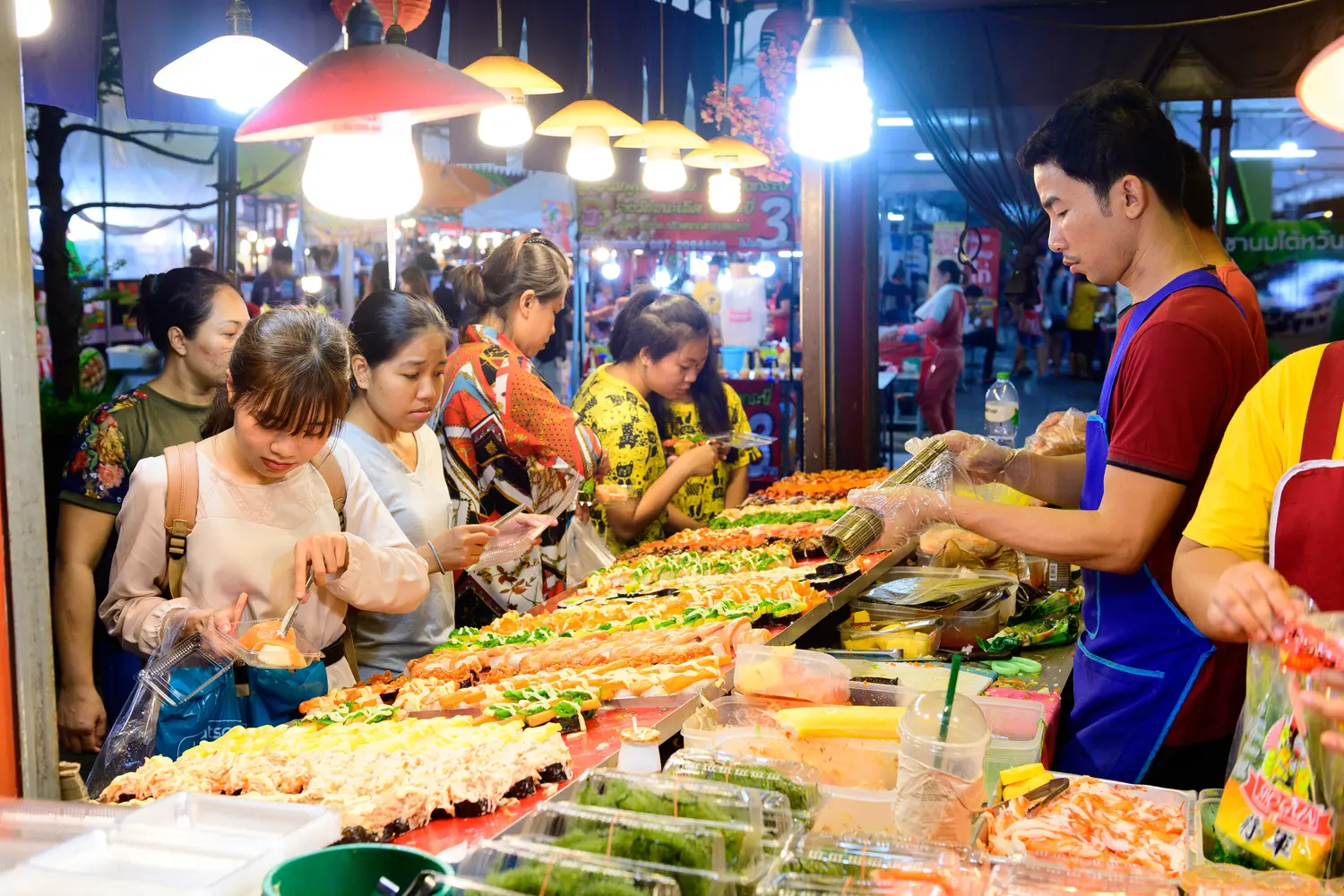 Thai night market with street vendors selling food.