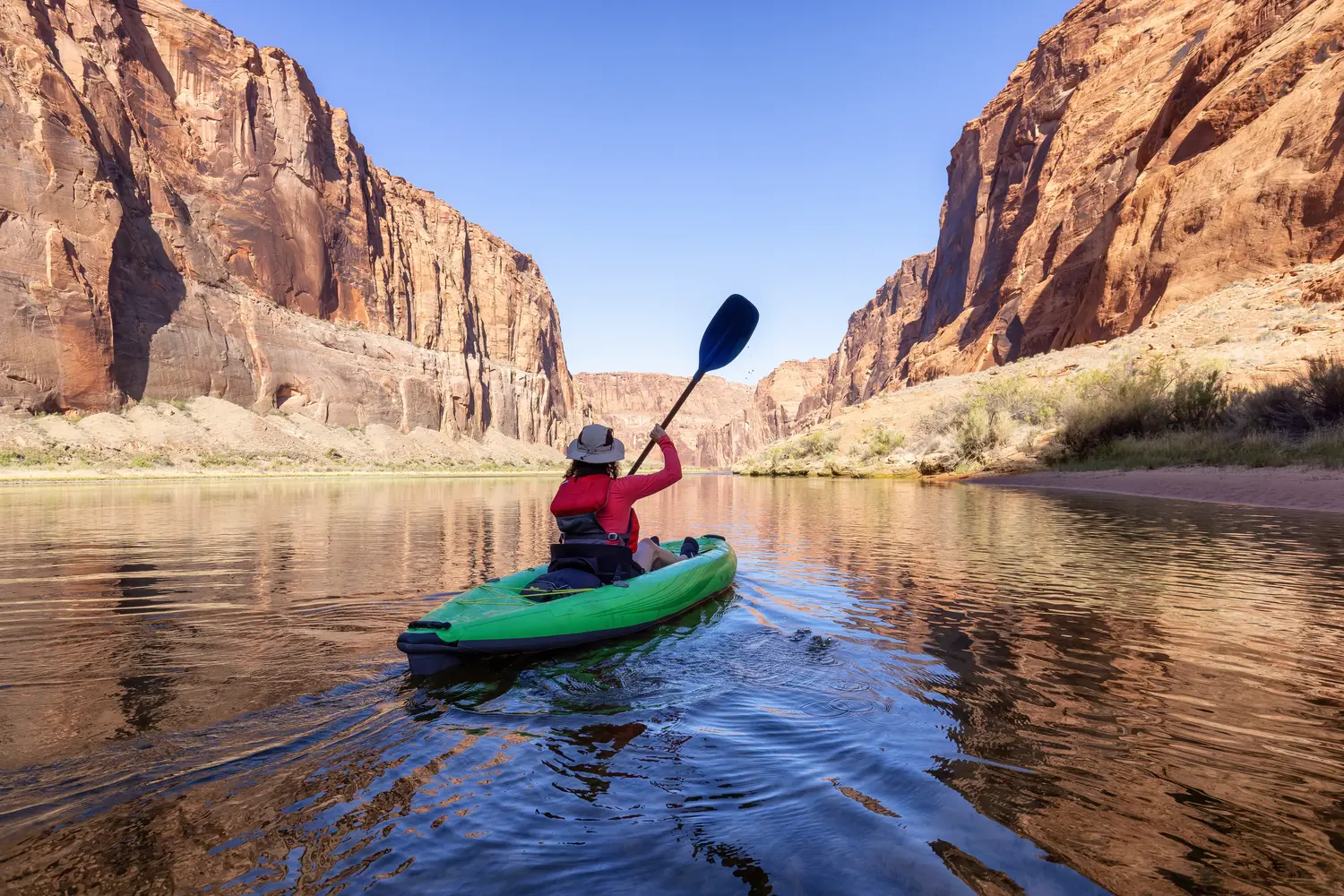Adventurous Woman on a Kayak paddling in Colorado River.